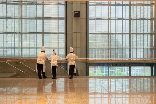 Wikimania 2023 day 3 18 August 2023, catering staff watching the setup of food for attendees. Catering event labor: the eight paid blocks of an event day