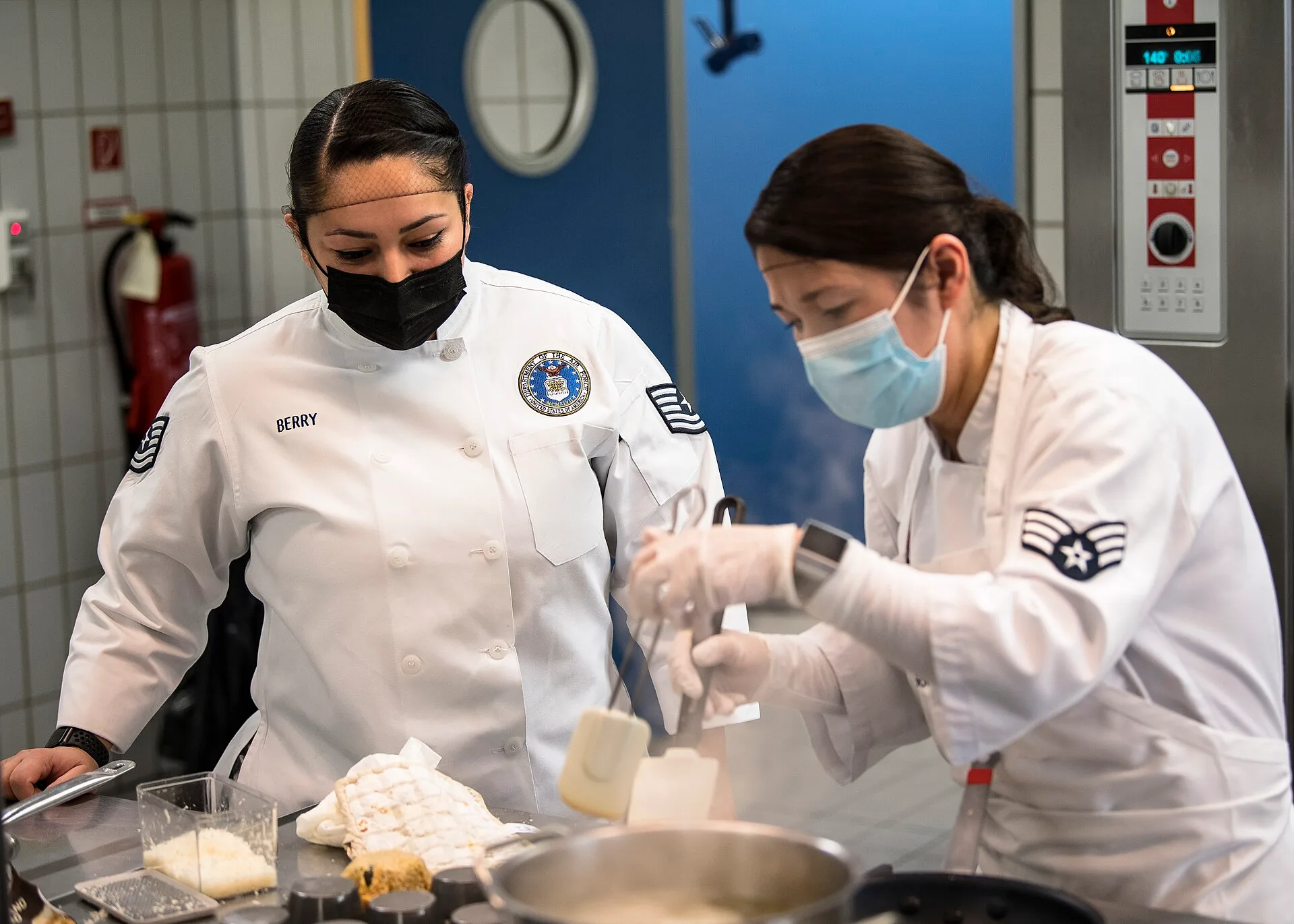 U.S. Air Force Tech. Sgt. April Berry, enlisted aide to the 3rd Air Force commander and dining facility Airman coach, watches over Senior Airman Alima Salimbaeva-Smith, 786th Force Support Squadron food services apprentice, during a cook-off competition at Kapaun Air Station, Germany, March 4, 2021. Building a training plan a new catering hire can follow